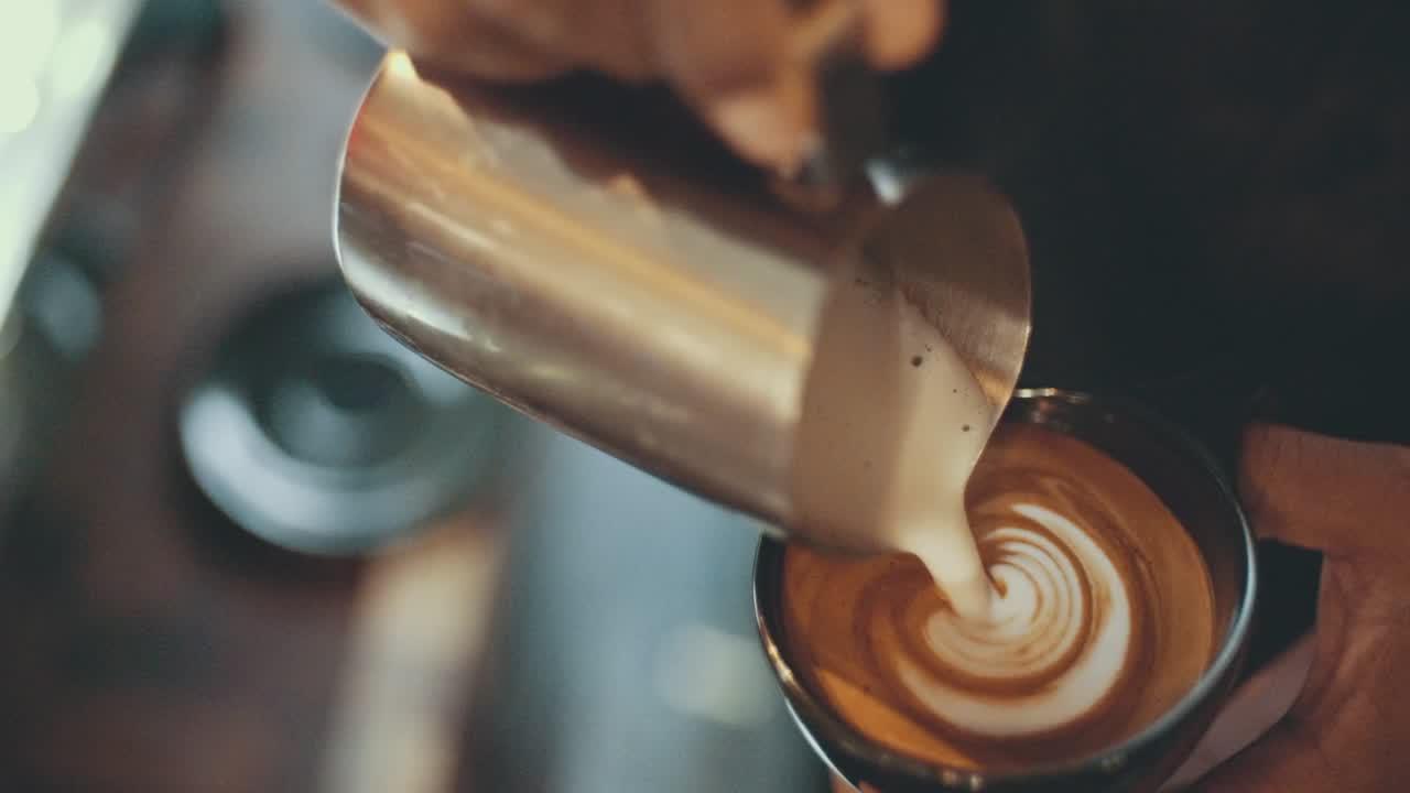 A barista pouring latte art